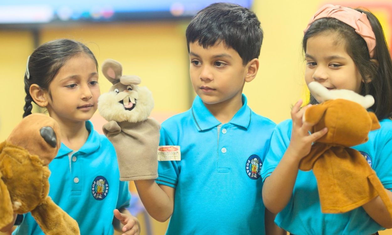 Preschool children learning emotional intelligence through interactive play-based activities.