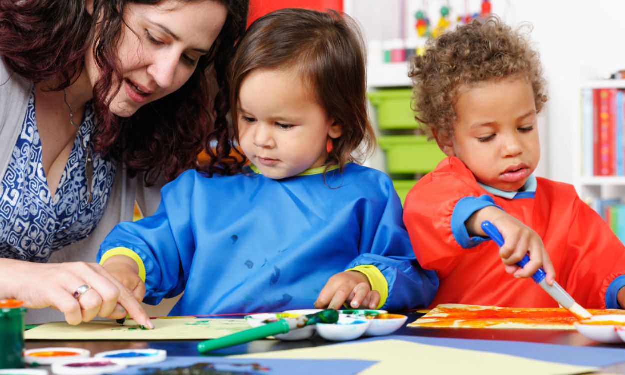 Preschool children sharing toys during playtime
