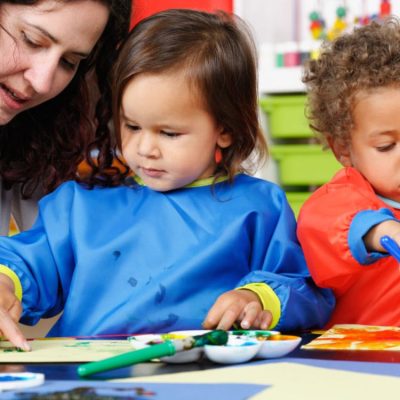 Preschool children sharing toys during playtime
